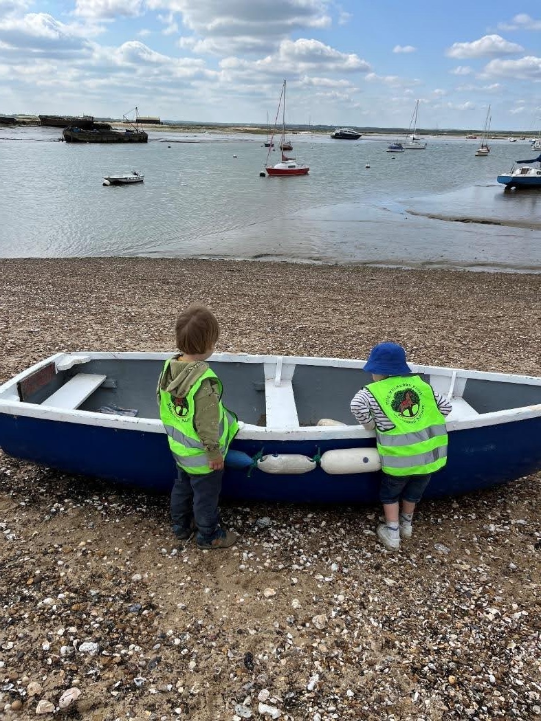 Children by boat on beach
