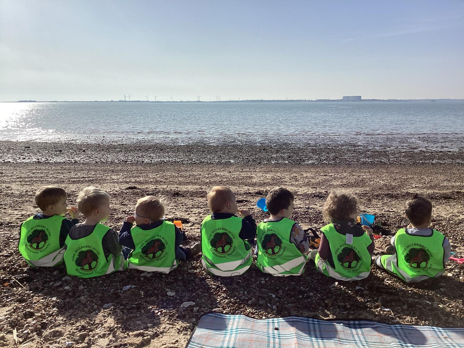 Children sitting together on the beach at West Mersea